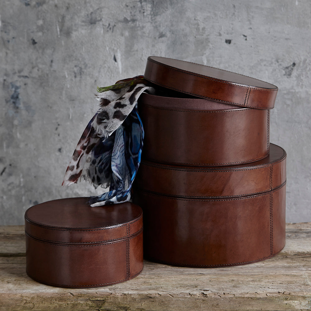 set of three leather round boxes