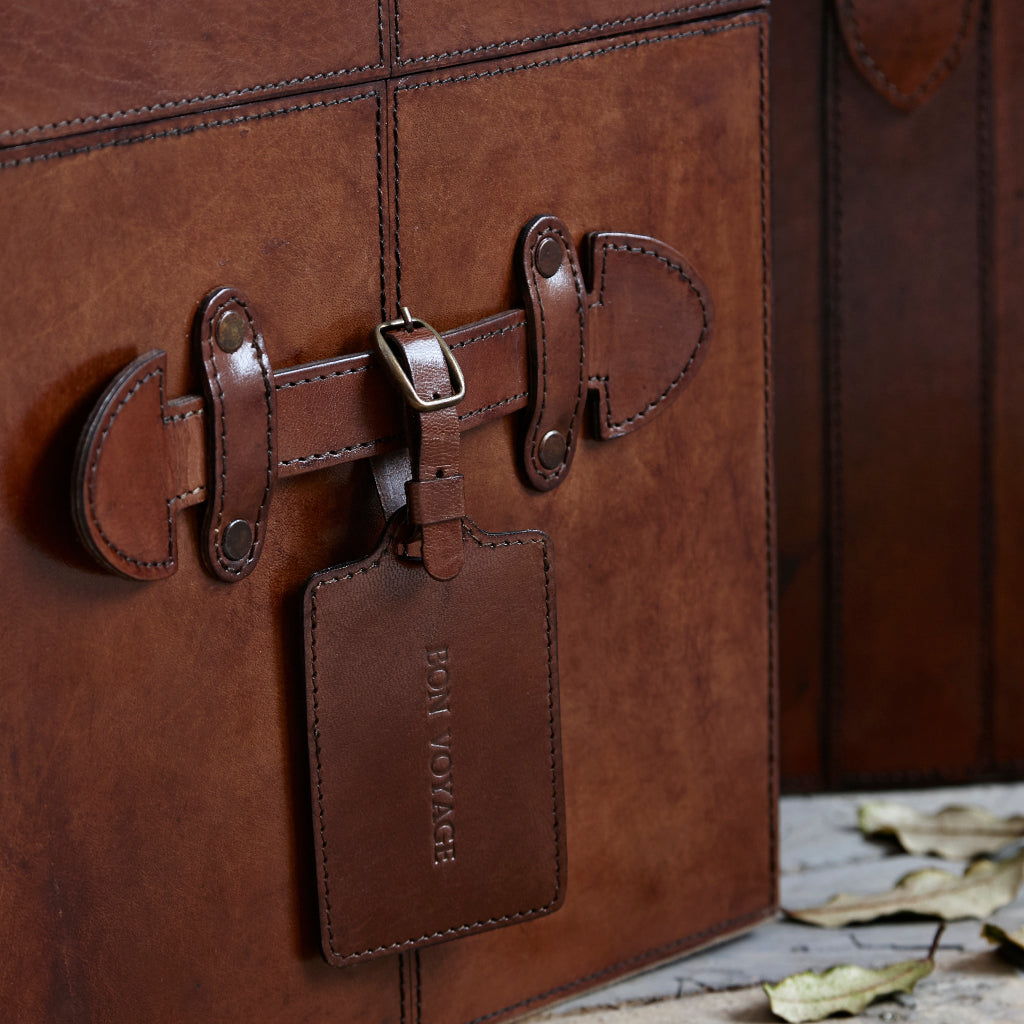 leather trunk with luggage tag hanging