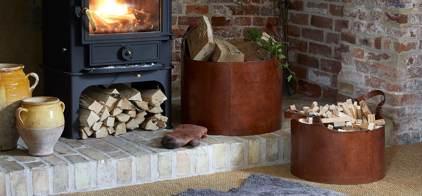 Set of two round storage baskets in inglenook fireplace